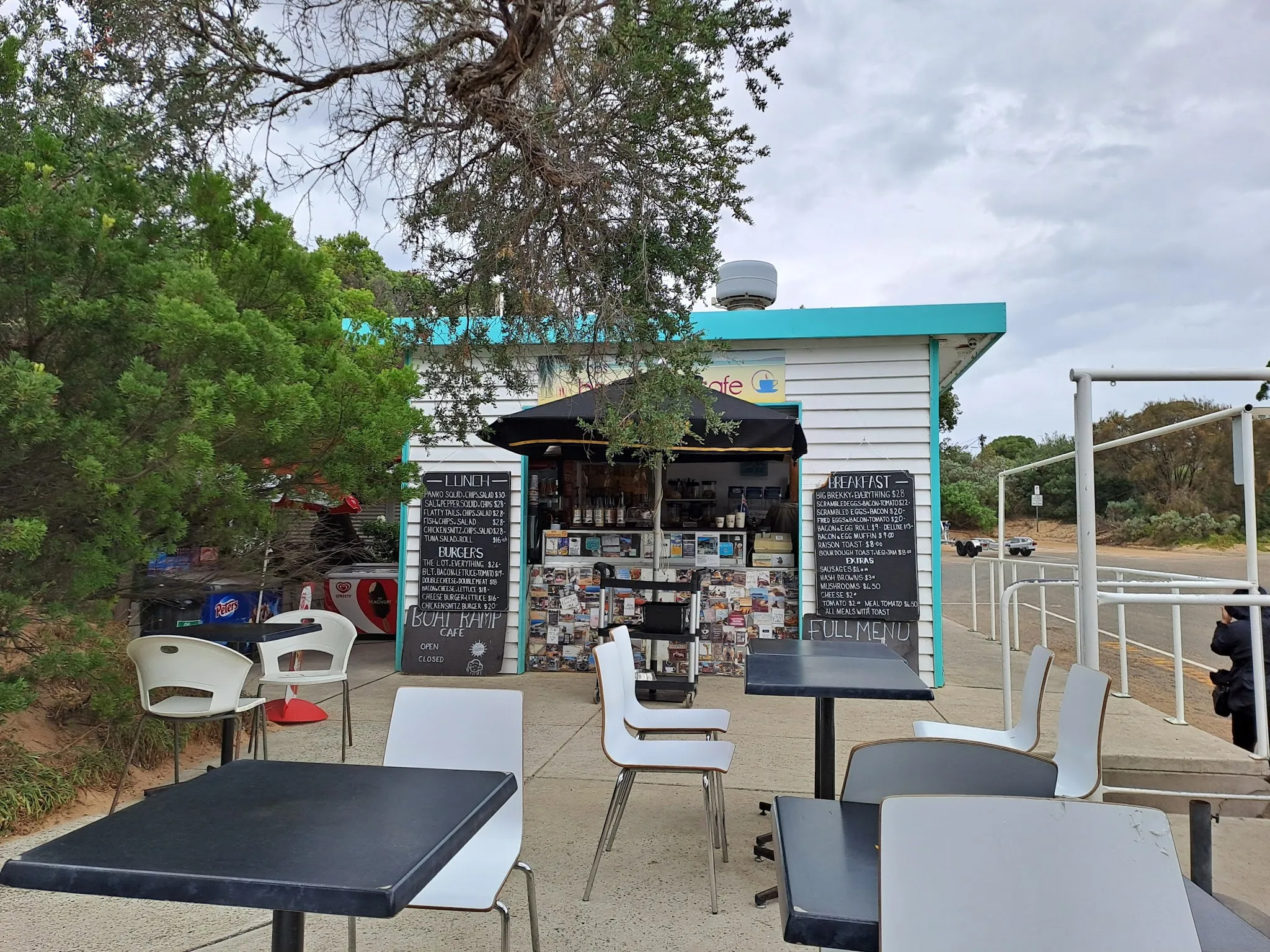 Boatramp Cafe kiosk with turquoise trim and chalkboard menus on overcast day